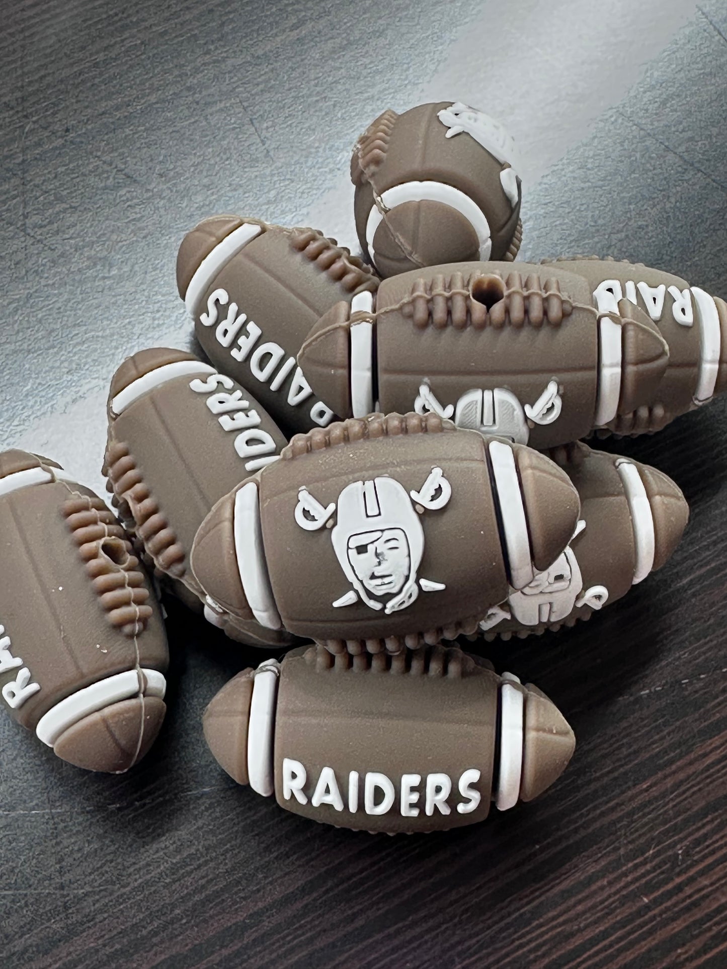3D Las Vegas Raiders focal bead / brown and white football shaped silicone bead