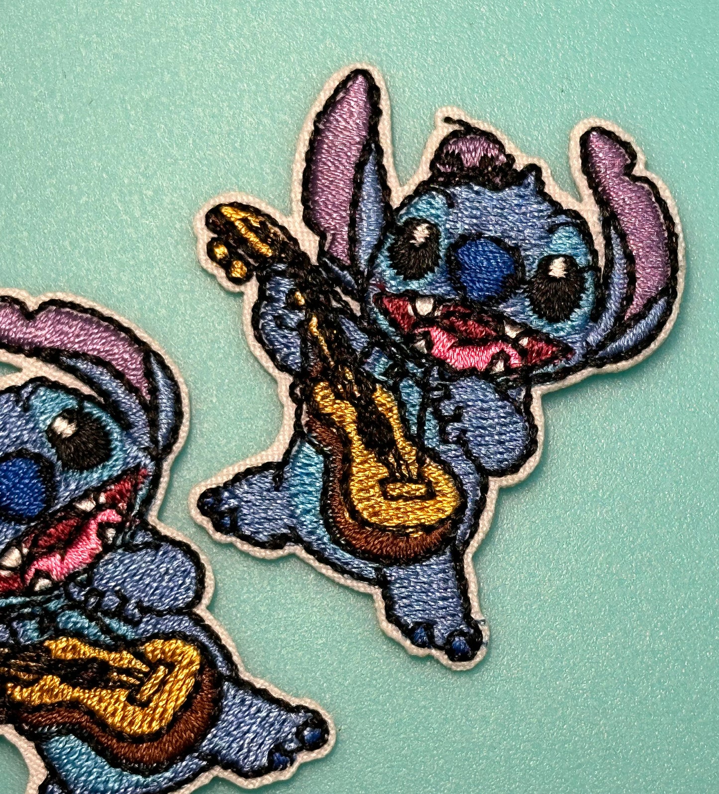 EVERYONES FAVORITE BLUE GUY PLAYING GUITAR IRON ON SMALL PATCH/ APPROX. 2" x 2"