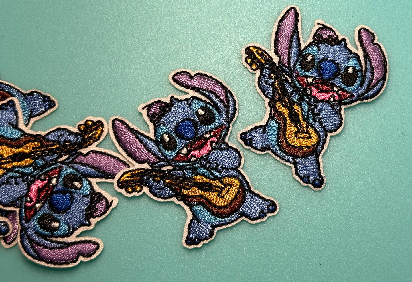 EVERYONES FAVORITE BLUE GUY PLAYING GUITAR IRON ON SMALL PATCH/ APPROX.  2" x 2"