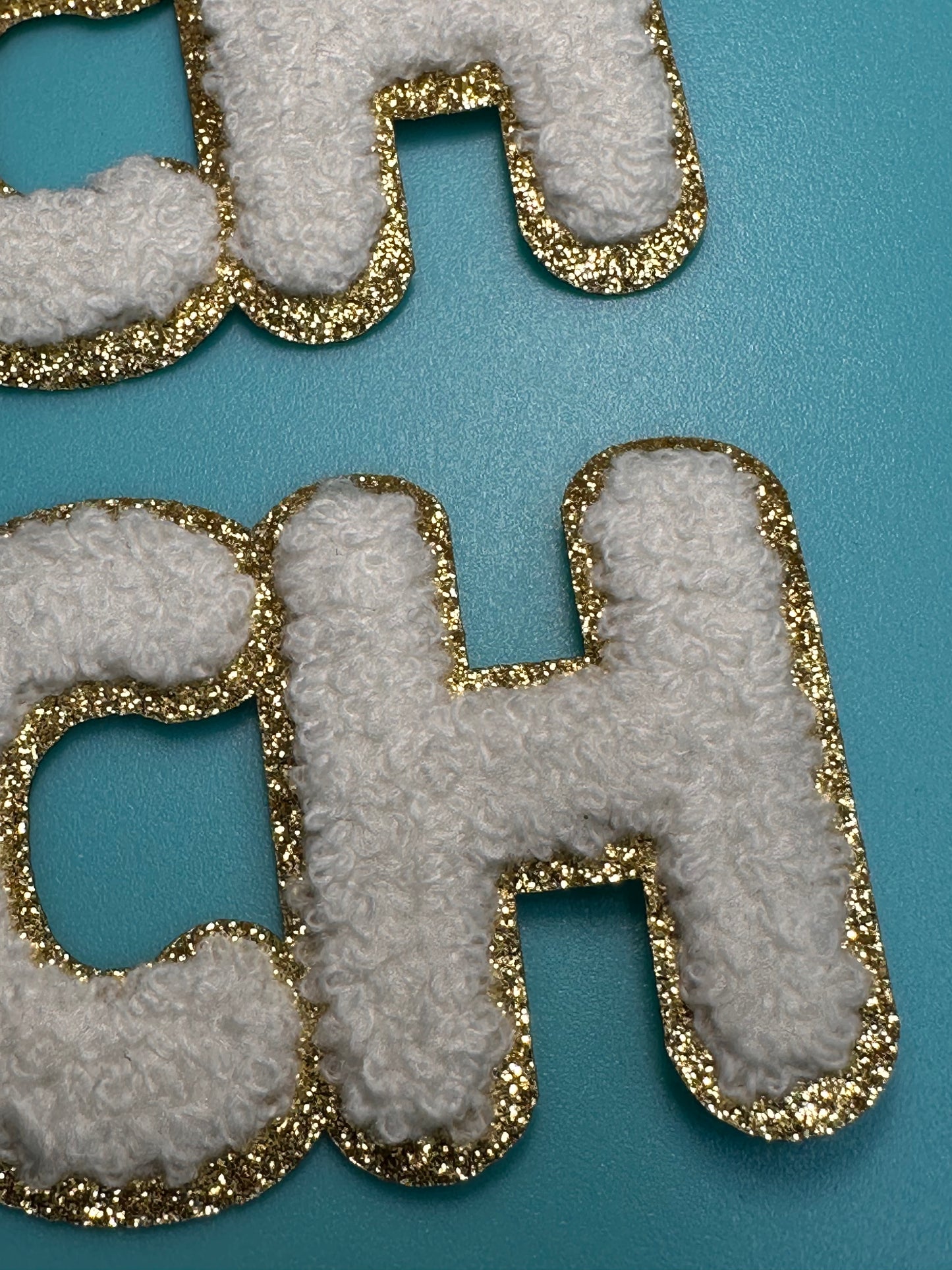 TEACH/ WHITE AND GOLD PATCH MEDIUM APPROX.  2x7 -WHITE CHENILLE AND GOLD GLITTER/ TEACHER