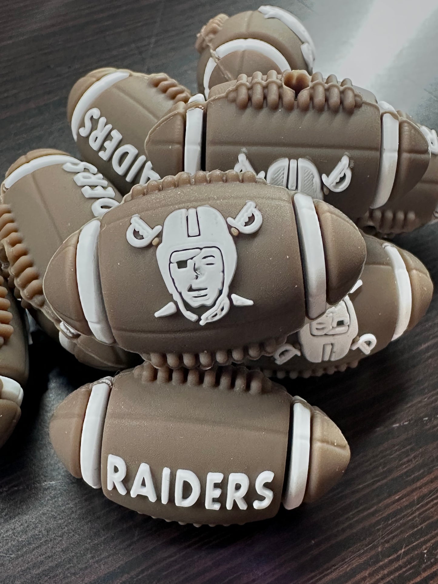 3D Las Vegas Raiders focal bead / brown and white football shaped silicone bead