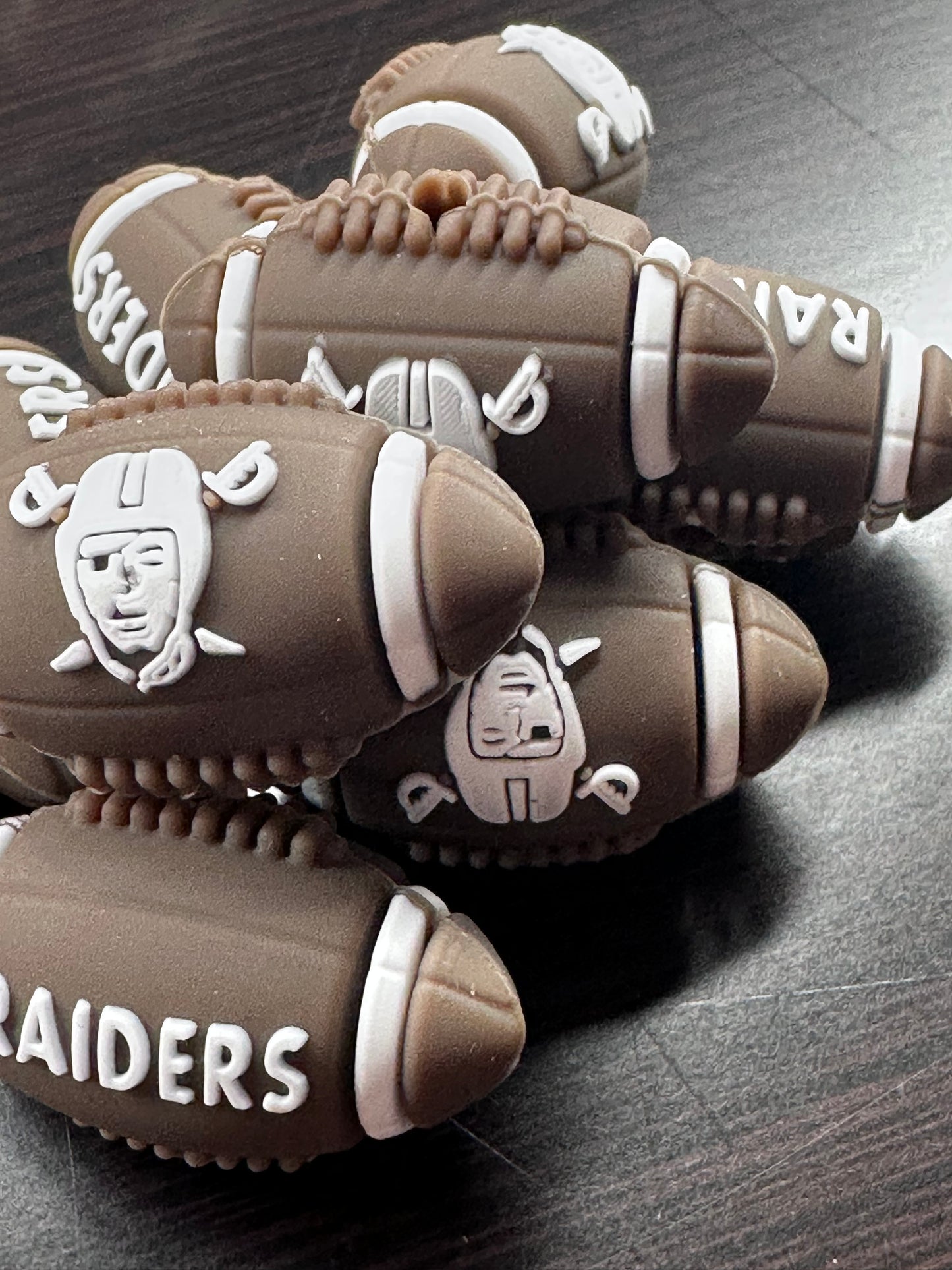 3D Las Vegas Raiders focal bead / brown and white football shaped silicone bead