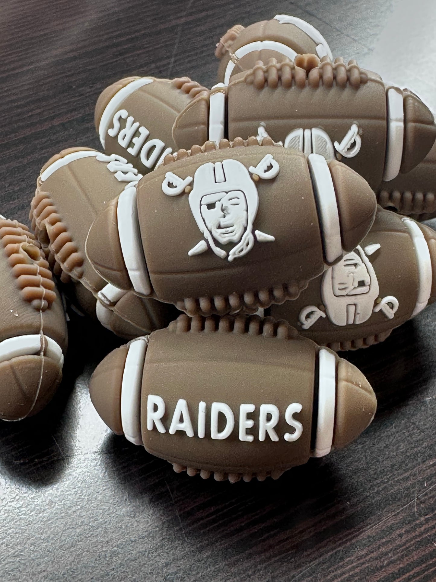 3D Las Vegas Raiders focal bead / brown and white football shaped silicone bead