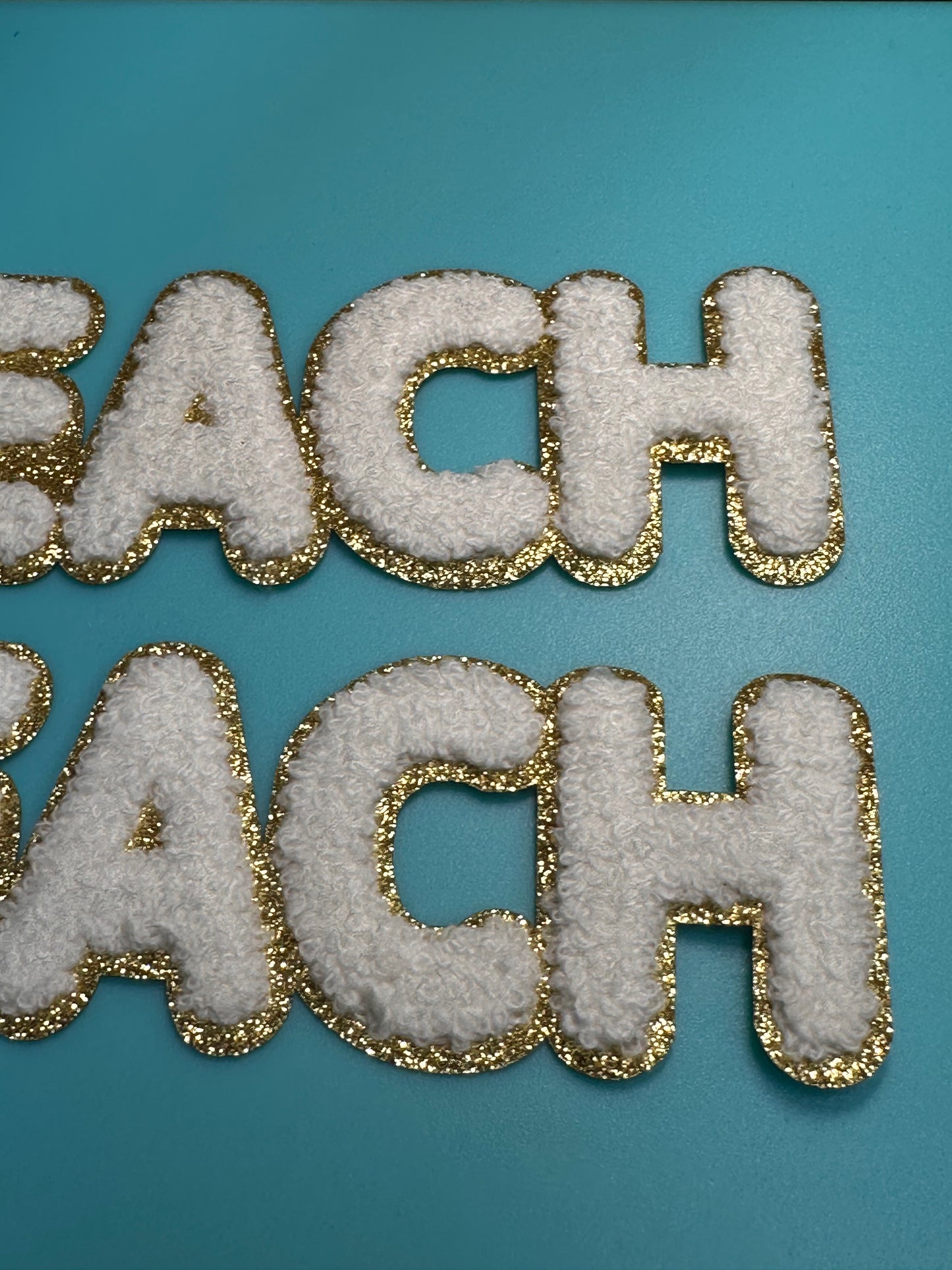 TEACH/ WHITE AND GOLD PATCH MEDIUM APPROX.  2x7 -WHITE CHENILLE AND GOLD GLITTER/ TEACHER